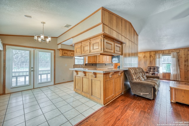 21440 Fm 306, Canyon Lake, TX 78133 - kitchen featuring a notable chandelier, open floor plan, a peninsula, light countertops, and visible vents