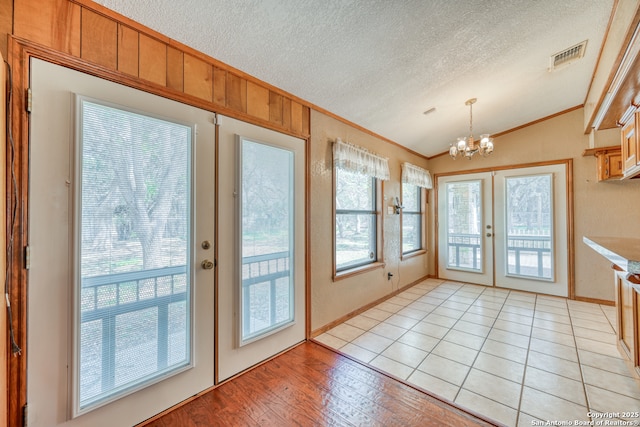 21440 Fm 306, Canyon Lake, TX 78133 - entryway featuring an inviting chandelier, vaulted ceiling, french doors, crown molding, and visible vents
