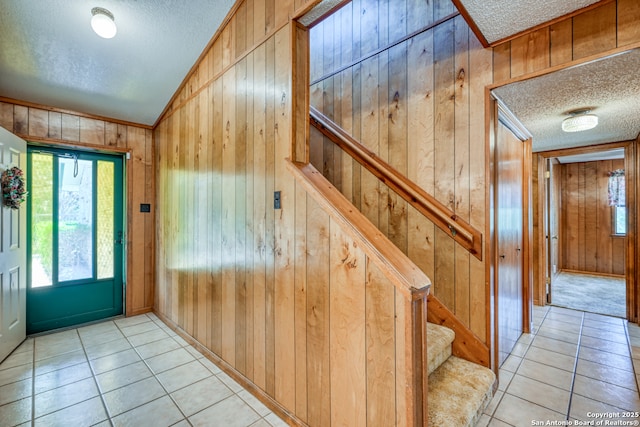 21440 Fm 306, Canyon Lake, TX 78133 - foyer entrance with a textured ceiling, wooden walls, and light tile patterned floors