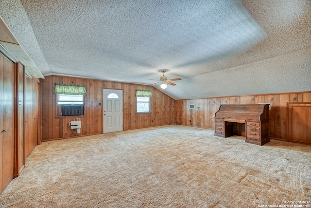 21440 Fm 306, Canyon Lake, TX 78133 - additional living space with wood walls, ceiling fan, a textured ceiling, and lofted ceiling