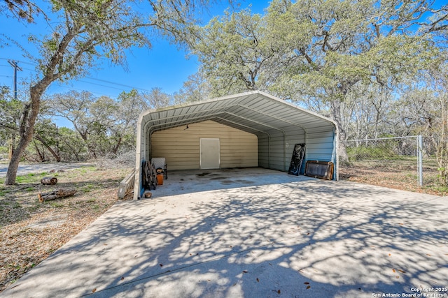 21440 Fm 306, Canyon Lake, TX 78133 - view of car parking featuring a detached carport, driveway, and fence