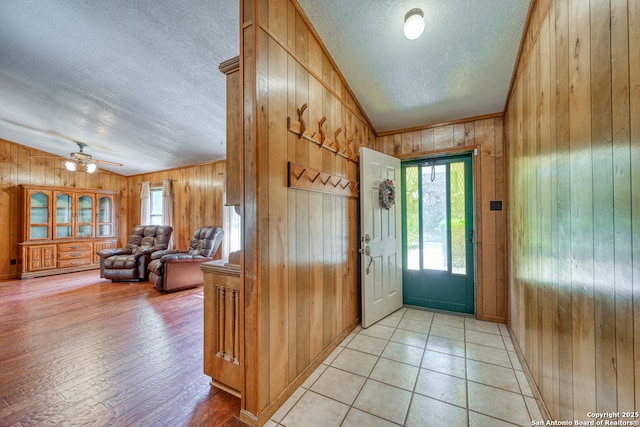 21440 Fm 306, Canyon Lake, TX 78133 - foyer entrance with wood walls, a textured ceiling, and vaulted ceiling