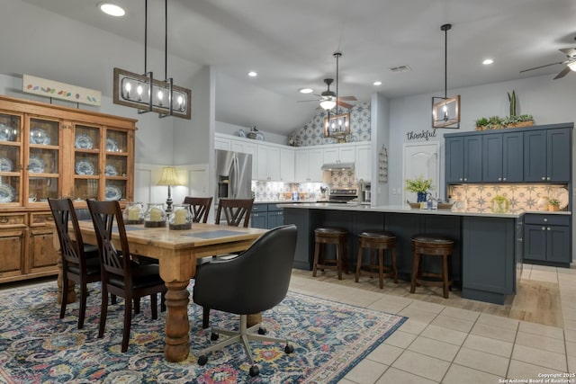 2239 Kensington Way, New Braunfels, TX 78130 - dining area with light tile patterned floors, a ceiling fan, visible vents, and lofted ceiling