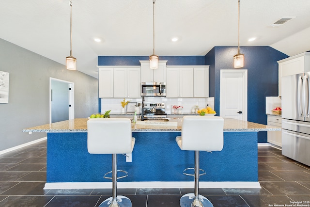 2700 La Mundial, Seguin, TX 78155 - kitchen with decorative backsplash, recessed lighting, a breakfast bar, and stainless steel appliances