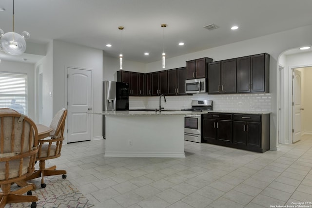8732 Ironwood Hl, San Antonio, TX 78254 - kitchen with appliances with stainless steel finishes, light tile patterned floors, backsplash, visible vents, and pendant lighting