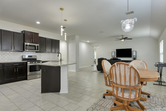 8732 Ironwood Hl, San Antonio, TX 78254 - kitchen with decorative backsplash, ceiling fan, visible vents, appliances with stainless steel finishes, and open floor plan