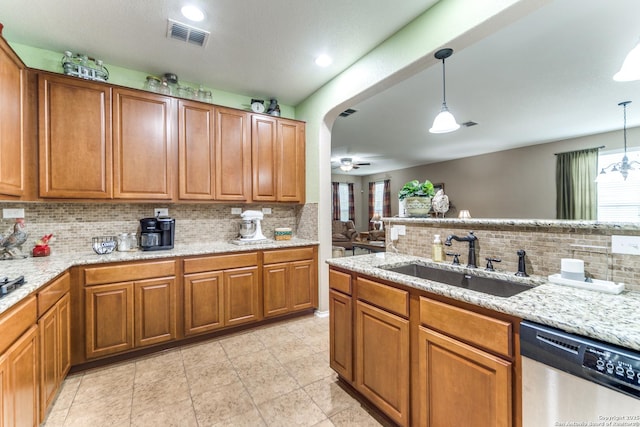 kitchen with a sink, decorative backsplash, plenty of natural light, and stainless steel dishwasher