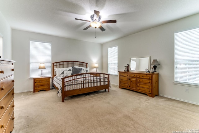 bedroom with baseboards, carpet, and a ceiling fan