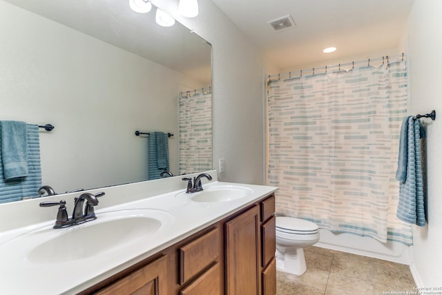 bathroom featuring a sink, toilet, double vanity, and visible vents