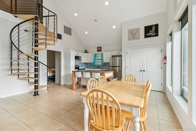 208 Woodridge, Canyon Lake, TX 78133 - dining area featuring recessed lighting, stairway, visible vents, light tile patterned floors, and high vaulted ceiling