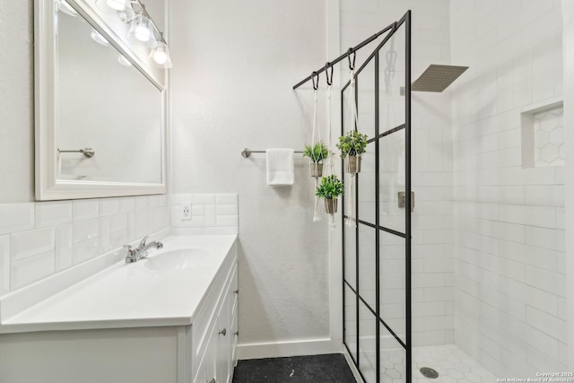 208 Woodridge, Canyon Lake, TX 78133 - bathroom with a tile shower, baseboards, and vanity