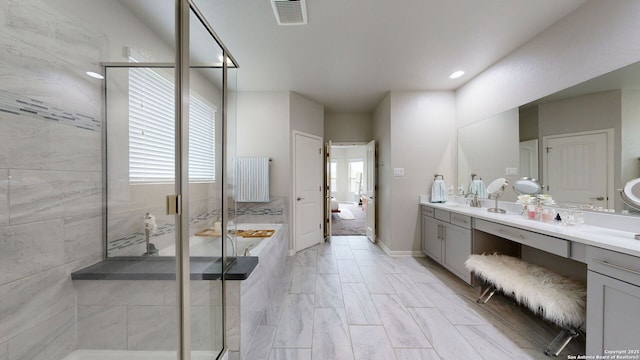 13324 Romulus Way, San Antonio, TX 78245 - bathroom featuring double vanity, a shower stall, a bath, plenty of natural light, and recessed lighting