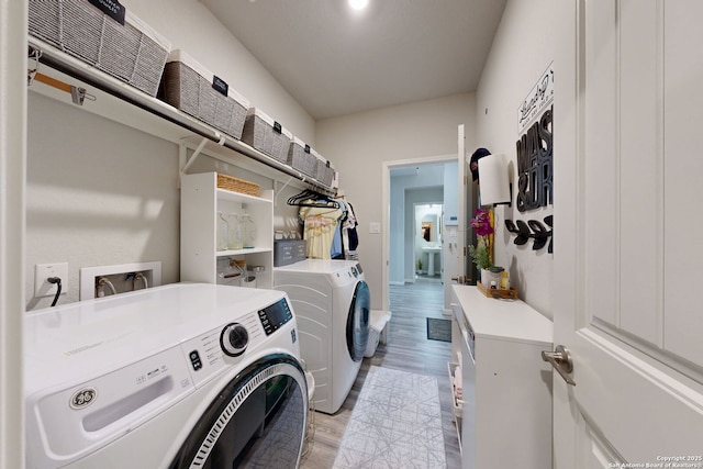 13324 Romulus Way, San Antonio, TX 78245 - laundry room with washer and dryer and light wood finished floors