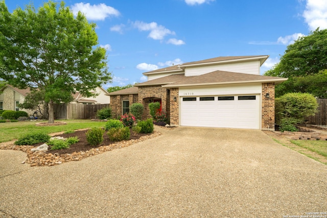 view of front of house with roof with shingles, driveway, fence, a garage, and brick siding