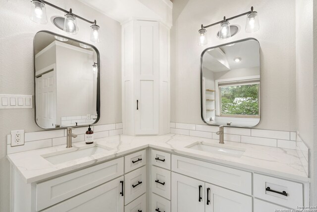 bathroom with double vanity and a sink
