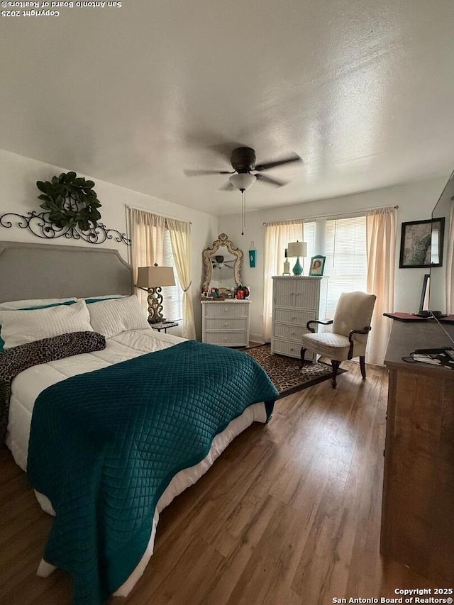 bedroom featuring wood finished floors and a ceiling fan