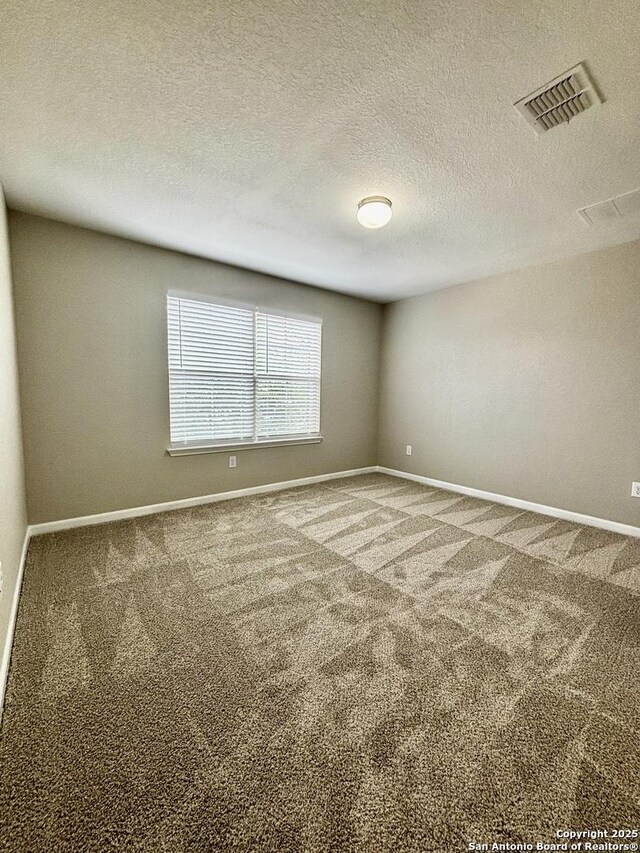 11631 Sangria, San Antonio, TX 78253 - unfurnished room with a textured ceiling, carpet flooring, baseboards, and visible vents