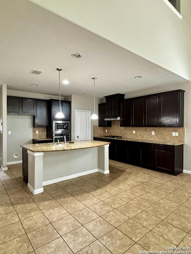 11631 Sangria, San Antonio, TX 78253 - kitchen with stainless steel appliances, visible vents, backsplash, and light stone counters