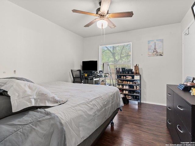 bedroom with ceiling fan, baseboards, and wood finished floors