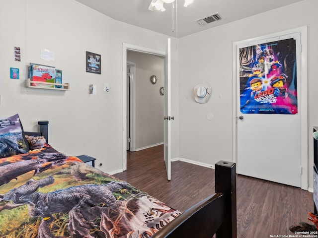 bedroom featuring visible vents, baseboards, and dark wood finished floors
