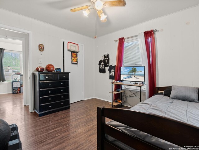 bedroom with dark wood-style floors, baseboards, and ceiling fan