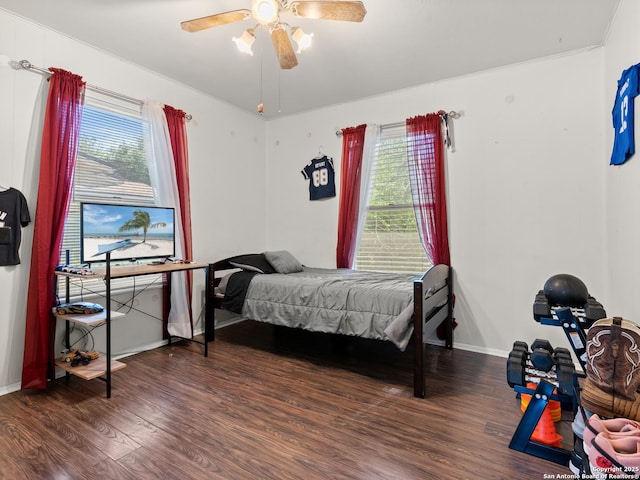 bedroom with baseboards, ceiling fan, and wood finished floors