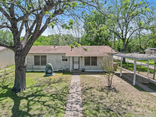 view of front facade featuring a front lawn, fence, and stone siding