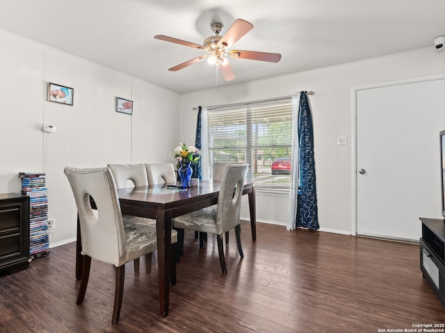 dining space with dark wood-type flooring, baseboards, and a ceiling fan