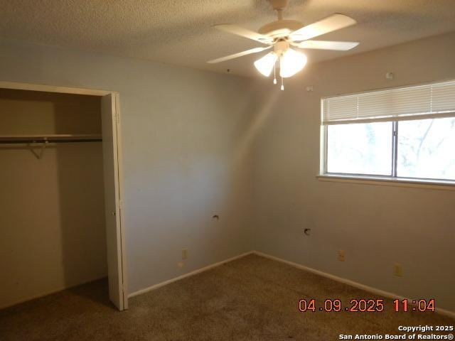 9704 Big Geronimo, San Antonio, TX 78254 - unfurnished bedroom with a closet, baseboards, a textured ceiling, and carpet floors
