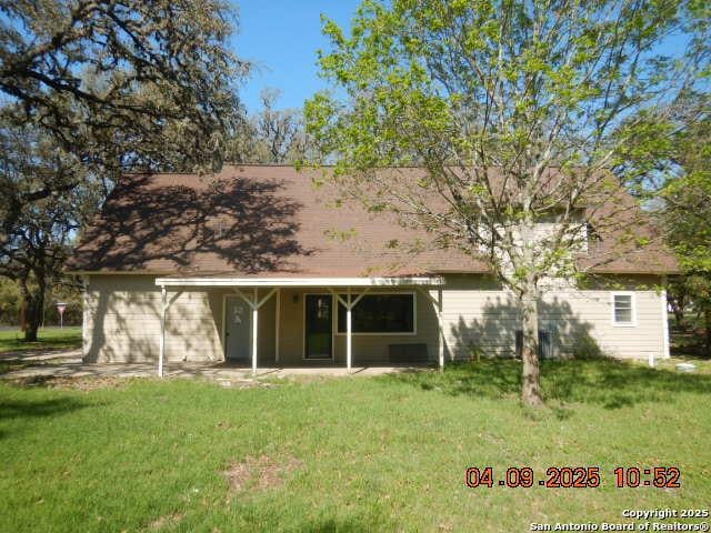 9704 Big Geronimo, San Antonio, TX 78254 - rear view of house with a patio area and a lawn
