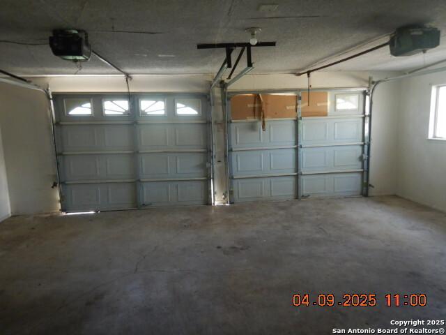 9704 Big Geronimo, San Antonio, TX 78254 - garage featuring a garage door opener