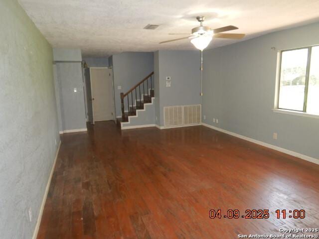 9704 Big Geronimo, San Antonio, TX 78254 - unfurnished room with visible vents, a ceiling fan, wood finished floors, and stairs