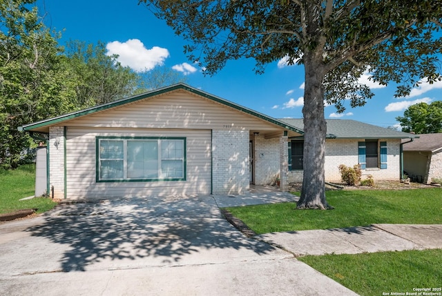 ranch-style house featuring a front yard and brick siding