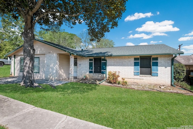 ranch-style house with a front yard, a shingled roof, and brick siding