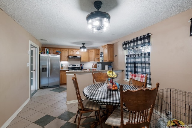dining space featuring visible vents, baseboards, light tile patterned flooring, and a textured ceiling