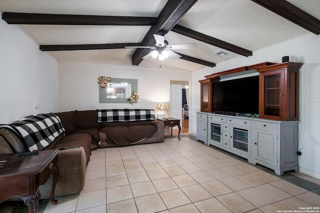 living room featuring light tile patterned floors, visible vents, a textured ceiling, and ceiling fan