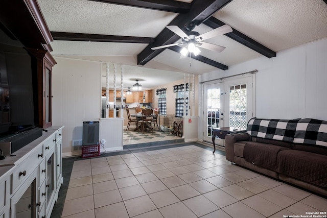 living room with light tile patterned floors, a textured ceiling, a ceiling fan, visible vents, and vaulted ceiling with beams