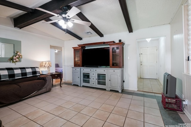 living room with visible vents, light tile patterned floors, ceiling fan, a textured ceiling, and vaulted ceiling with beams