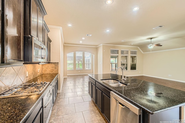 805 Raceland, San Antonio, TX 78245 - kitchen featuring visible vents, a sink, stainless steel appliances, open floor plan, and decorative backsplash