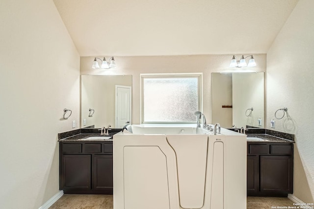 805 Raceland, San Antonio, TX 78245 - full bath with a bath, two vanities, a sink, and baseboards