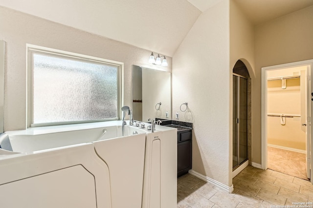 805 Raceland, San Antonio, TX 78245 - bathroom with a shower stall, a walk in closet, a bath, and baseboards