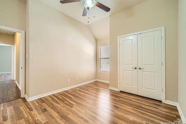 805 Raceland, San Antonio, TX 78245 - unfurnished bedroom featuring a closet, baseboards, visible vents, lofted ceiling, and wood finished floors