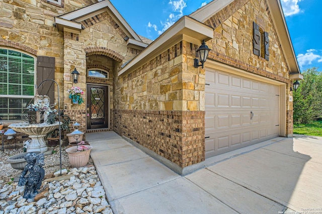 805 Raceland, San Antonio, TX 78245 - view of exterior entry with a garage, stone siding, and concrete driveway
