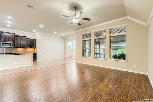 805 Raceland, San Antonio, TX 78245 - unfurnished living room featuring recessed lighting, visible vents, ceiling fan, arched walkways, and light wood finished floors