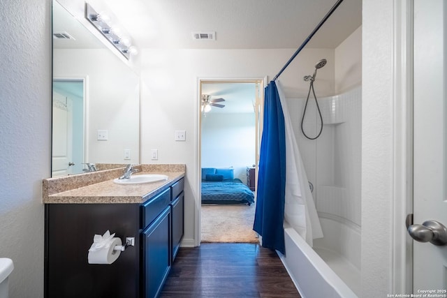 bathroom with visible vents, shower / bathtub combination with curtain, vanity, and wood finished floors