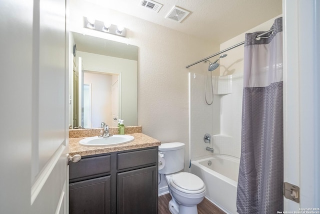 bathroom featuring shower / bath combination with curtain, vanity, visible vents, and toilet