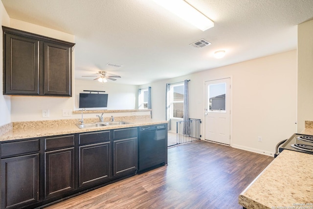 kitchen with a peninsula, light countertops, black dishwasher, a sink, and wood finished floors