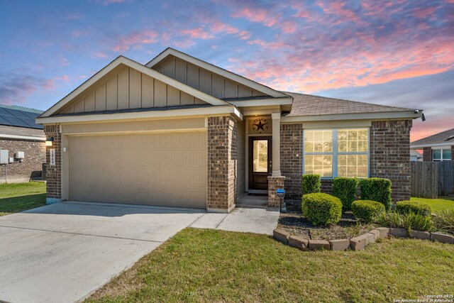ranch-style home featuring board and batten siding, an attached garage, brick siding, and concrete driveway
