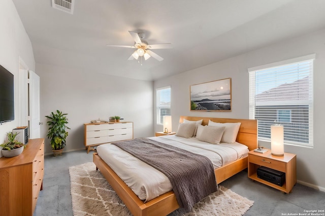 carpeted bedroom with visible vents, baseboards, and ceiling fan
