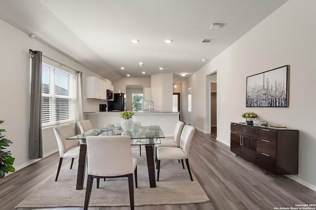 dining room featuring baseboards, vaulted ceiling, recessed lighting, visible vents, and wood finished floors
